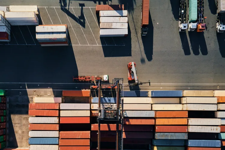 Top view of colorful containers at a port, symbolizing large-scale freight and container transport.