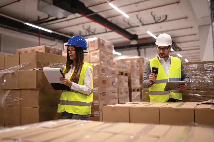 Two warehouse employees inspecting packages for same-day courier delivery to Sydney.