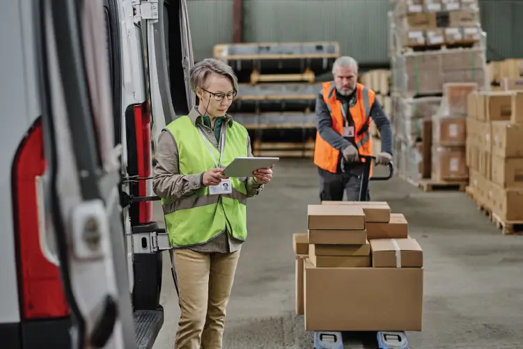 employees managing logistics and package loading in a warehouse for efficient freight services
